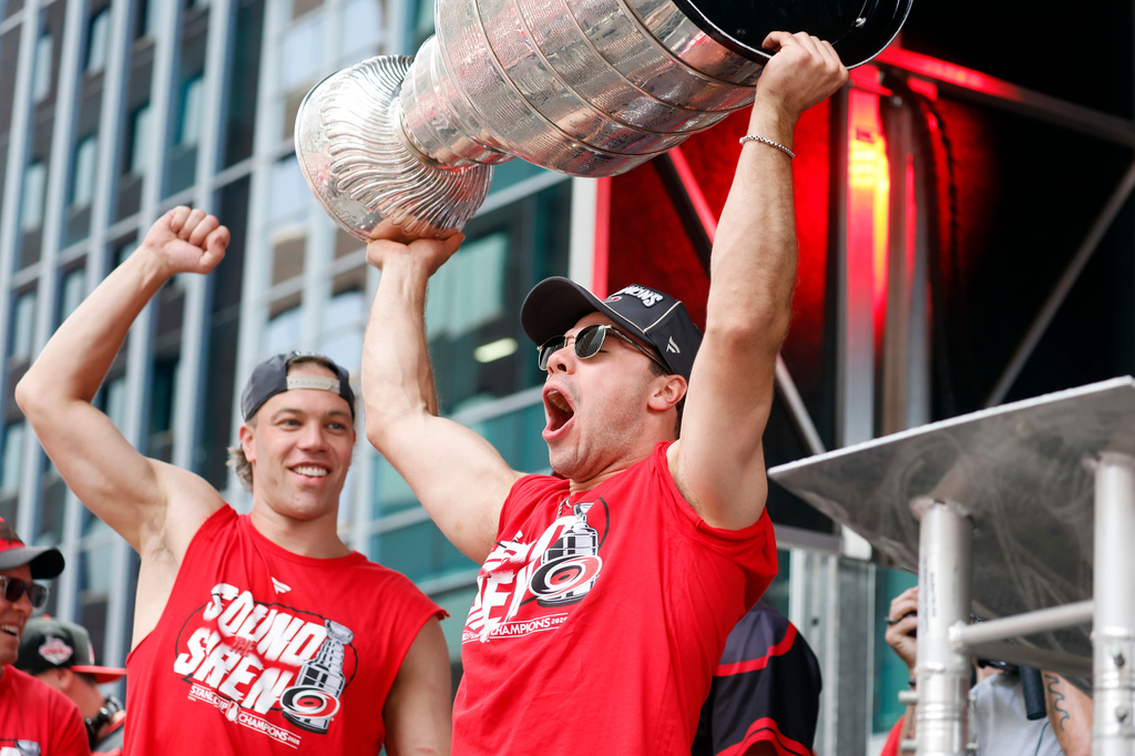 Carolina Hurricanes' Logan Stankoven, right, holds up the Stanley Cup with Taylor Hall during the NHL hockey club's championship celebration in Raleigh, N.C., Saturday, June 20, 2026. (AP Photo/Karl DeBlaker)