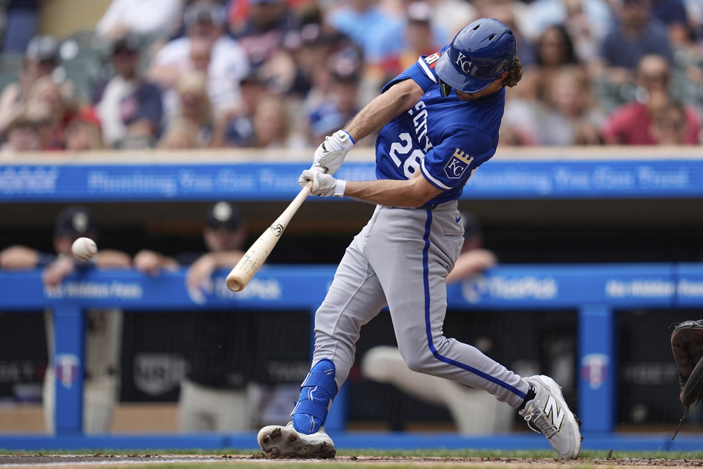 Kansas City Royals' Adam Frazier hits a RBI-single during the first inning of a baseball game against the Minnesota Twins, Sunday, Aug. 10, 2025, in Minneapolis. (AP Photo/Abbie Parr)