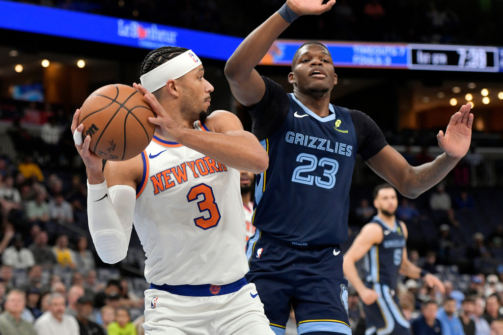 New York Knicks guard Josh Hart (3) handles the ball against Memphis Grizzlies forward Cedric Coward (23) in the first half of an NBA basketball game Wednesday, April 1, 2026, in Memphis, Tenn. (AP Photo/Brandon Dill)