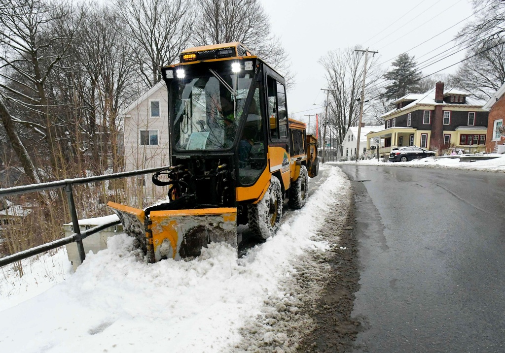 A sidewalk plow from the Brattleboro, Vt., Department of Public Works clears off the sidewalk on Green Street on Wednesday, Jan. 7, 2026. (Kristopher Radder /The Brattleboro Reformer via AP)