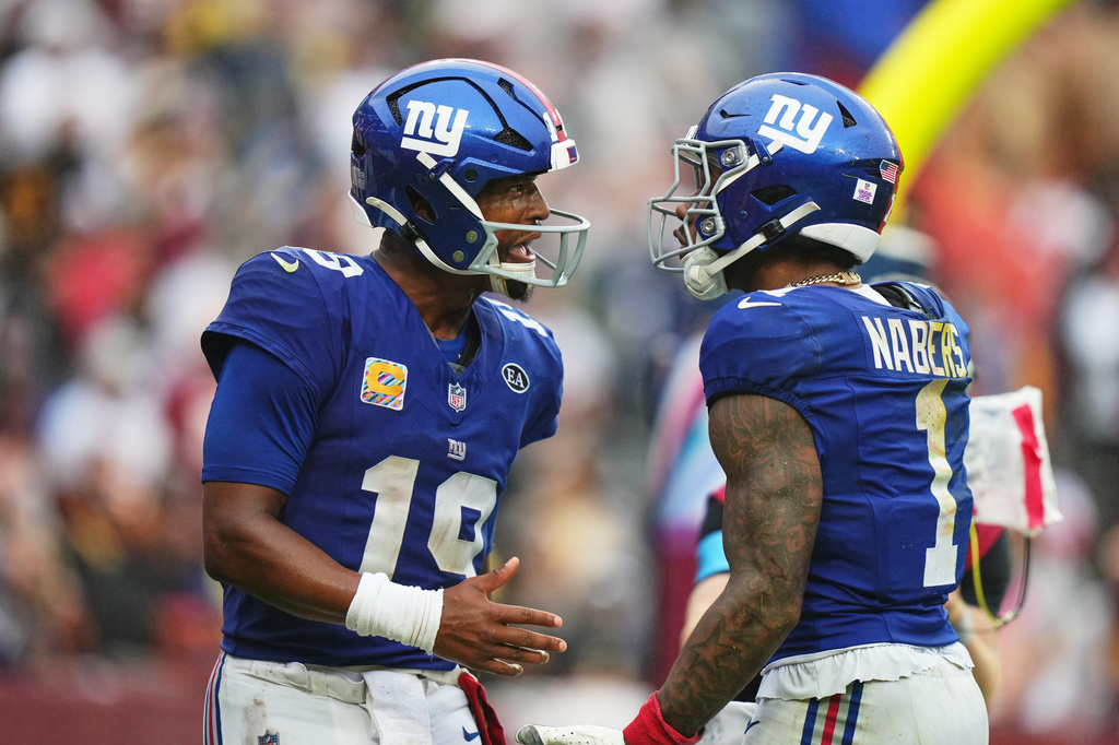 New York Giants quarterback Jameis Winston (19) celebrates with Malik Nabers (1) after they connected for a touchdown during the second half of an NFL football game against the Washington Commanders in Landover, Md., Sunday, Oct. 11, 2026. (AP Photo/Stephanie Scarbrough)