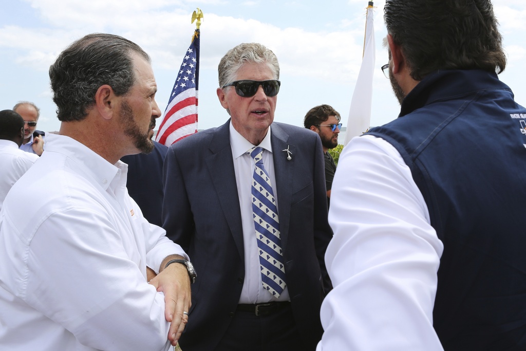 FILE - Rhode Island Gov. Dan McKee, center, speaks with Laborers' International Union of North America leaders Donato Bianco, left, and Michael Sabitoni, right, after a news conference in North Kingstown, R.I., on Aug. 25, 2025. (AP Photo/Jennifer McDermott, File)