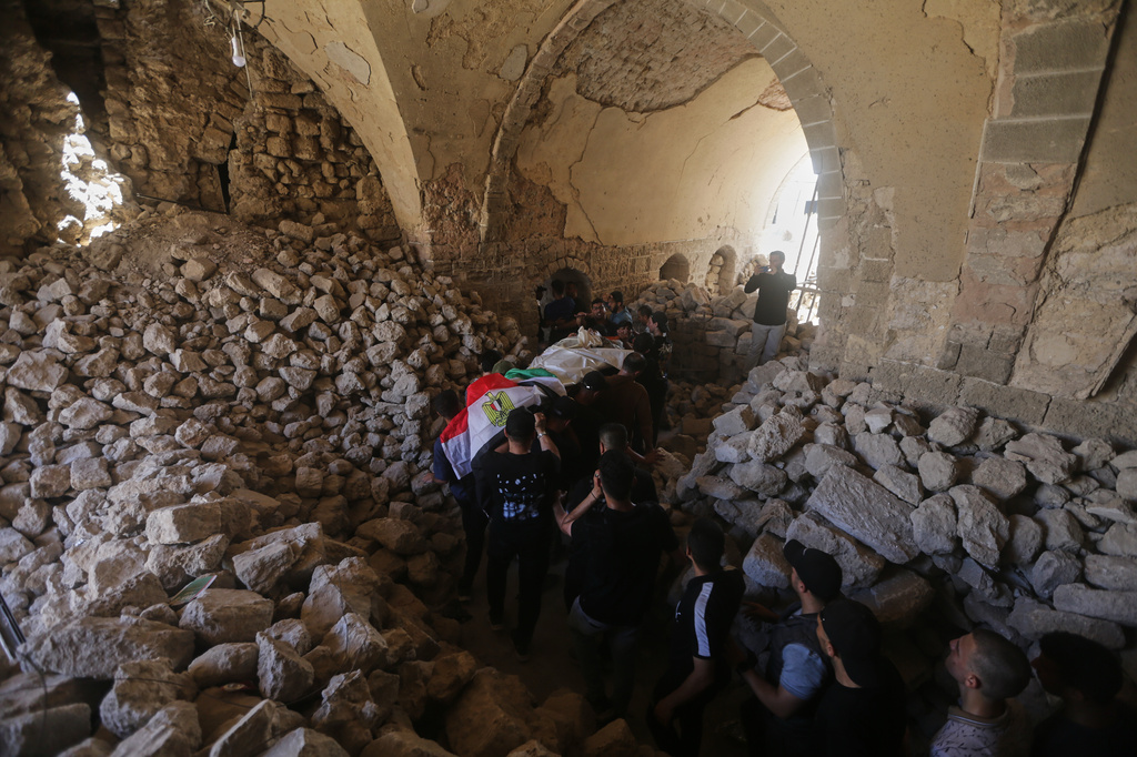 Palestinians carry the body of Mohamed al-Wahidi, director of public relations for the Egyptian Committee in Gaza, who was killed in an Israeli military strike, during his funeral at the Great Omari Mosque in Gaza City, Wednesday, July 8, 2026. (AP Photo/Yousef Al Zanoun)