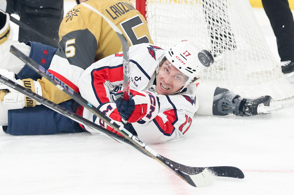 Washington Capitals center Dylan Strome (17) contests for a loose puck against the Vegas Golden Knights during the first period of an NHL hockey game Saturday, March 28, 2026, in Las Vegas. (AP Photo/Ian Maule)