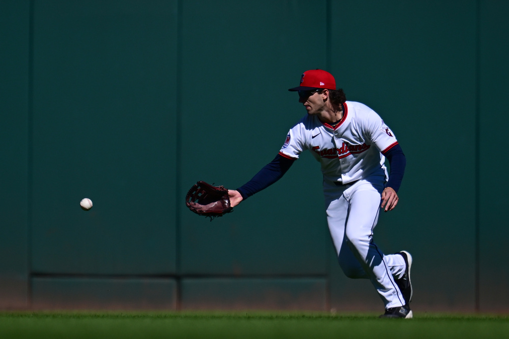 Cleveland Guardians center fielder Chase DeLauter misses a ball hit by Detroit Tigers' Gleyber Torres for a fielding error in the first inning of Game 2 of the American League Wild Card baseball playoff series in Cleveland, Wednesday, Oct. 1, 2025. (AP Photo/David Dermer)