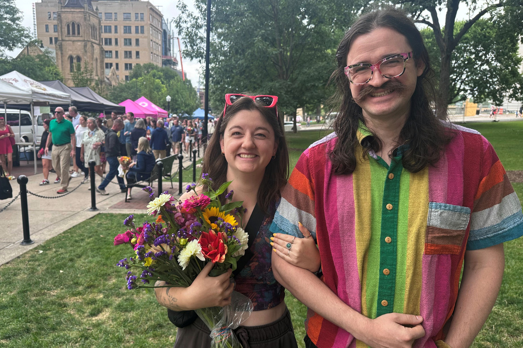 Alison Berube, left, and Charles Ault are photographed at the farmers market on Saturday, July 25, 2026, in Madison, Wis. (AP Photo/Scott Bauer) CORRECTION: corrects spelling of Charles' last name to Ault, not Alt