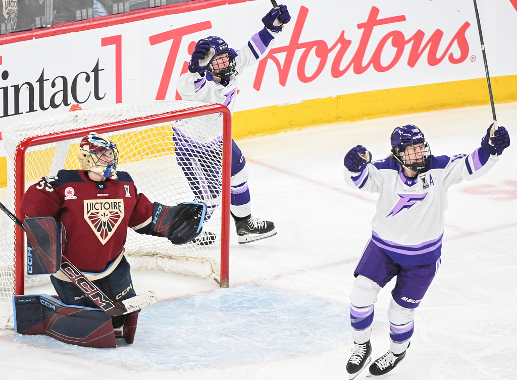 Montreal Victoire goaltender Ann-Renee Desbiens (35) looks as Minnesota Frost's Kelly Pannek (12) and Grace Zumwinkle (13) celebrate a goal by teammate Jincy Roese (not shown) during the overtime of an PWHL playoff hockey game in Laval, Que., Saturday, May 2, 2026. (Graham Hughes/The Canadian Press via AP)