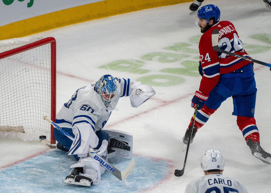 Montreal Canadiens' Phillip Danault (24) scores on Toronto Maple Leafs goaltender Joseph Woll (60) during first period NHL hockey action in Montreal on Tuesday, March 10, 2026. (Christinne Muschi/The Canadian Press via AP)