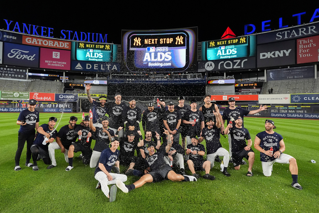 The New York Yankees pose for a team photo on the field after defeating the Boston Red Sox in Game 3 of an American League wild-card baseball playoff series, Thursday, Oct. 2, 2025, in New York. (AP Photo/Frank Franklin II)