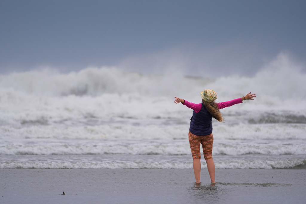 Brenda Malloy enjoys a nor'easter storm, Friday, Sept. 25, 2026, in Gloucester, Mass. (AP Photo/Robert F. Bukaty)