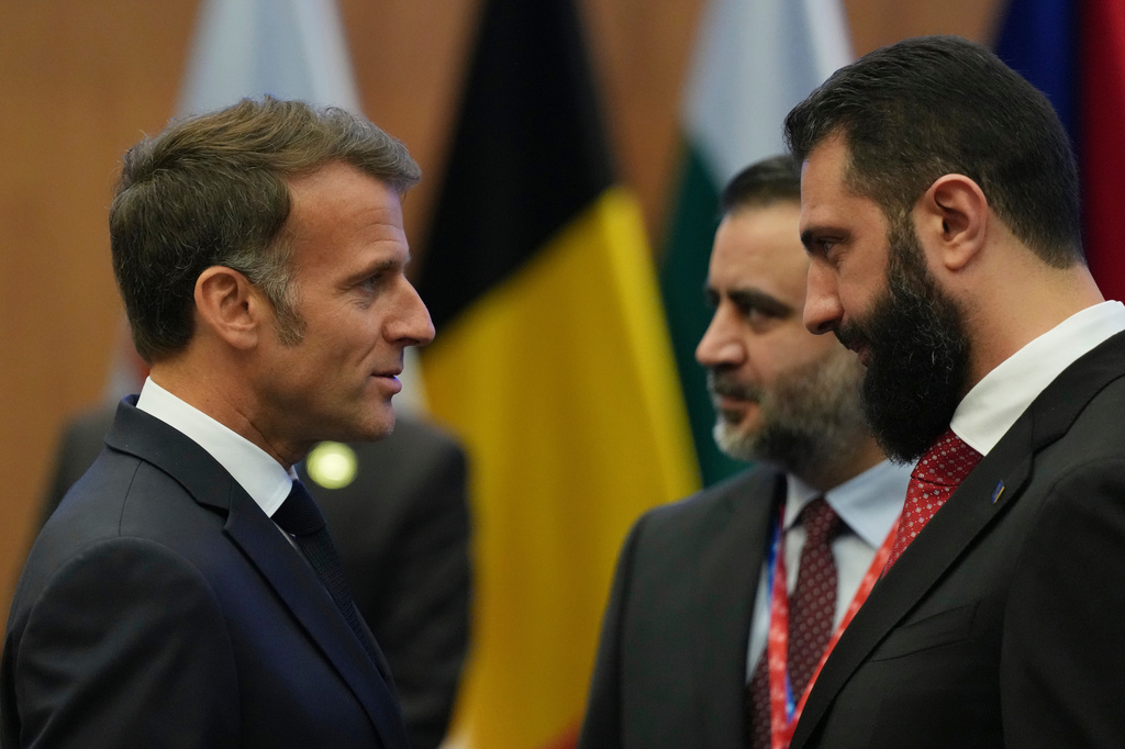 French President Emmanuel Macron, left, talks with the Syrian President Ahmad al-Sharaa during the EU Summit in Nicosia, Cyprus, Friday, April 24, 2026. (AP Photo/Petros Karadjias)