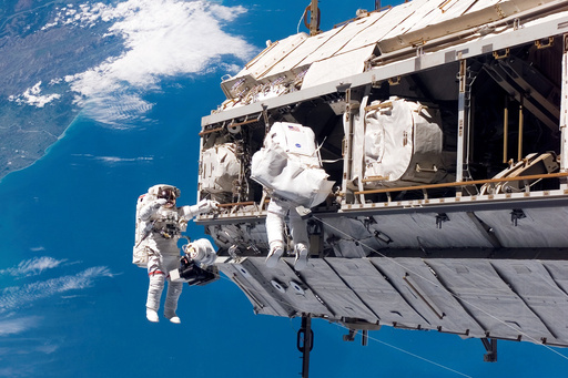 FILE - In this photo provided by NASA, astronaut Robert L. Curbeam Jr., left, and European Space Agency astronaut Christer Fuglesang, participate in a spacewalk during construction of the International Space Station on Dec. 12, 2006. In the background are New Zealand and the Pacific Ocean. (NASA via AP, File) FILE - In this photo provided by NASA, astronaut Robert L. Curbeam Jr., left, and European Space Agency astronaut Christer Fuglesang, participate in a spacewalk during construction of the International Space Station on Dec. 12, 2006. In the background are New Zealand and the Pacific Ocean. (NASA via AP, File)