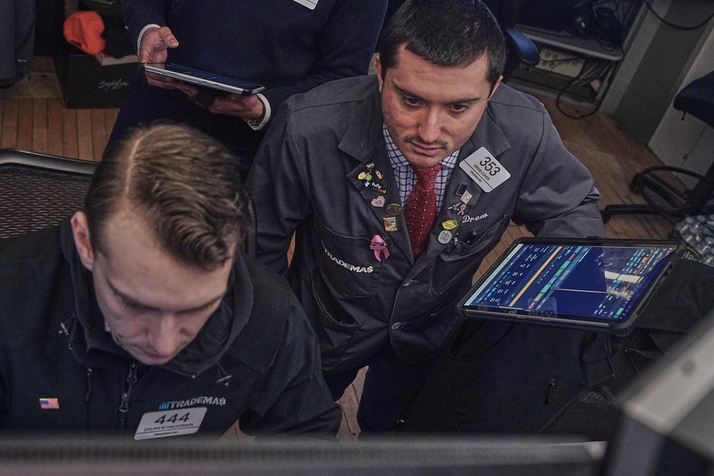 Traders Dylan Halvorsan, left, and Drew Cohen work on the floor of the New York Stock Exchange, Friday, Feb. 13, 2026, in New York. (AP Photo/Richard Drew)