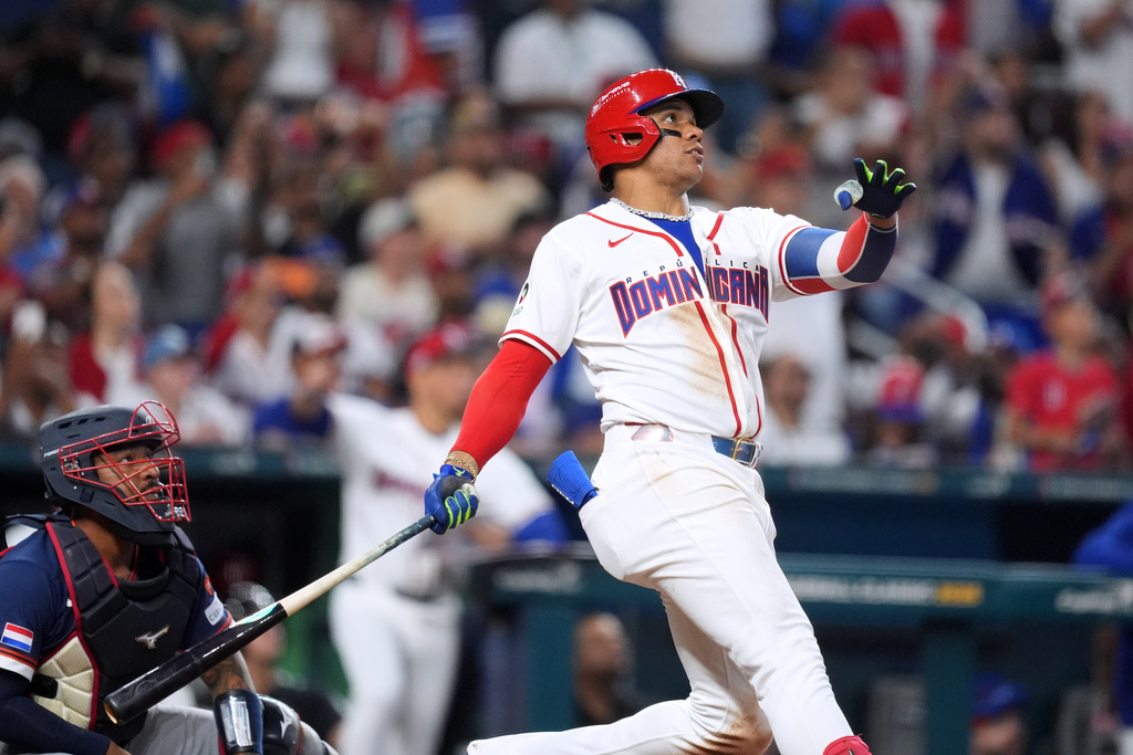 Dominican Republic's Juan Soto watches his ball as he hits a two-run homer to win by early termination in the seventh inning of a World Baseball Classic game against the Netherlands, Sunday, March 8, 2026, in Miami. (AP Photo/Rebecca Blackwell)