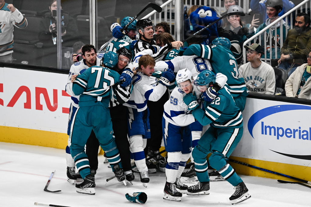 A fight breaks out between the Tampa Bay Lightning and San Jose Sharks during the second period of an NHL hockey game Saturday, Jan. 3, 2026, in San Jose, Calif. (AP Photo/Thien-An Truong)