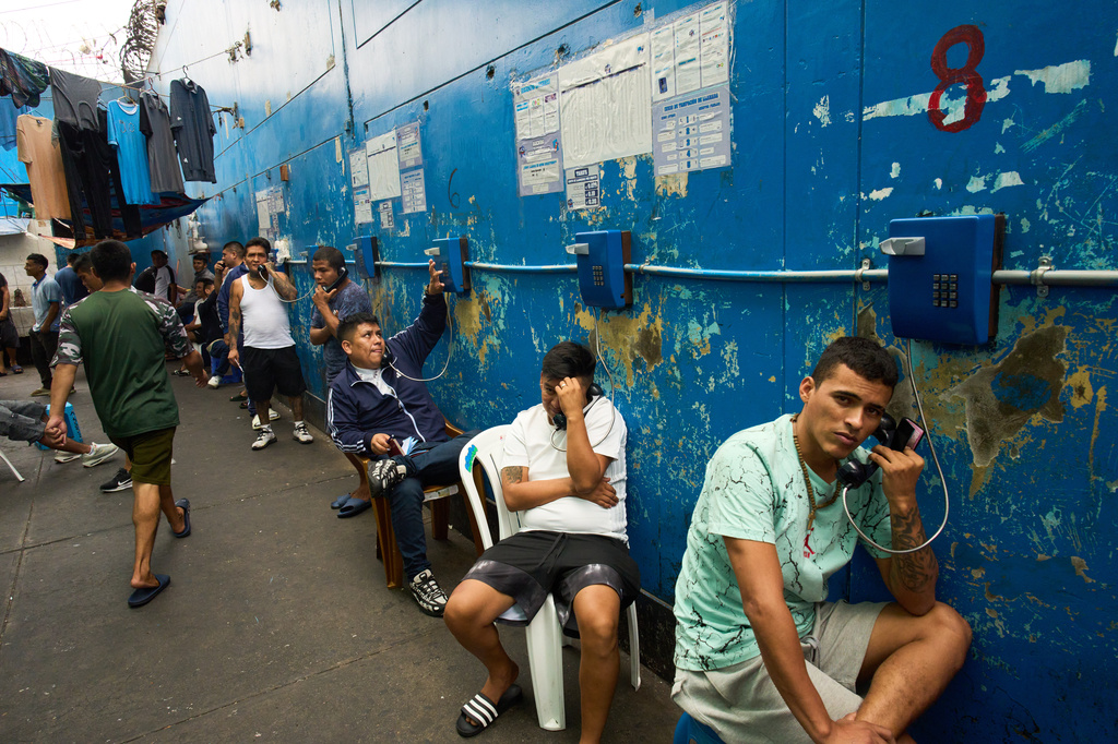 Inmates make phone calls at El Milagro Prison in Trujillo, Peru, Wednesday, May 20, 2026. (AP Photo/Rodrigo Abd)