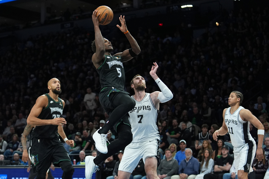 Minnesota Timberwolves guard Anthony Edwards (5) drives to the basket past San Antonio Spurs center Luke Kornet (7) during the first half of Game 4 of an NBA basketball second-round playoffs series in Minneapolis, Sunday, May 10, 2026. (AP Photo/Abbie Parr)
