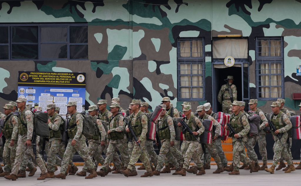 Members of the military stand in formation before their departure to protect polling places in Lima, Peru, Friday, June 5, 2026, ahead of their presidential runoff election. (AP Photo/Martin Mejia)