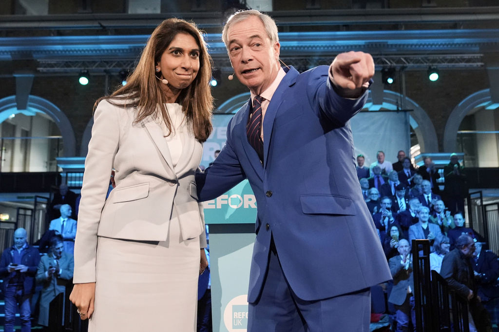 Reform UK leader Nigel Farage and former home secretary Suella Braverman speaking during a Reform UK press conference in London, Monday, Jan. 26, 2026, after announcing Braverman has defected to the party. (Stefan Rousseau/PA via AP)