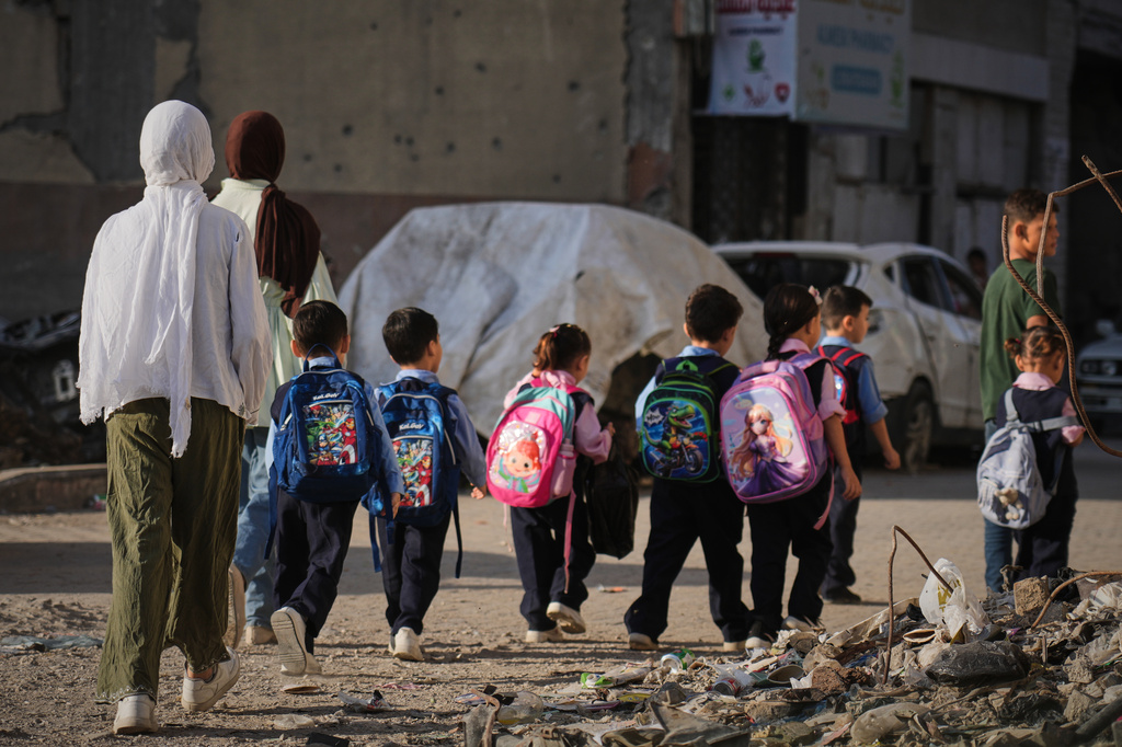 Young Palestinian students make their way to school in Gaza City, Monday, Sept. 28, 2026. (AP Photo/Jehad Alshrafi)