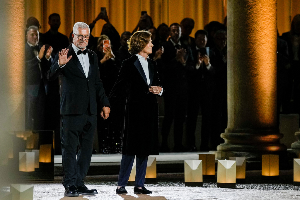 Leo Dell'Orco, left, and Silvana Armani acknowledge the applause at the end of the Giorgio Armani Spring/Summer 2026 collection show in Milan, Italy, Sunday, Sept. 28, 2025. (AP Photo/Luca Bruno)