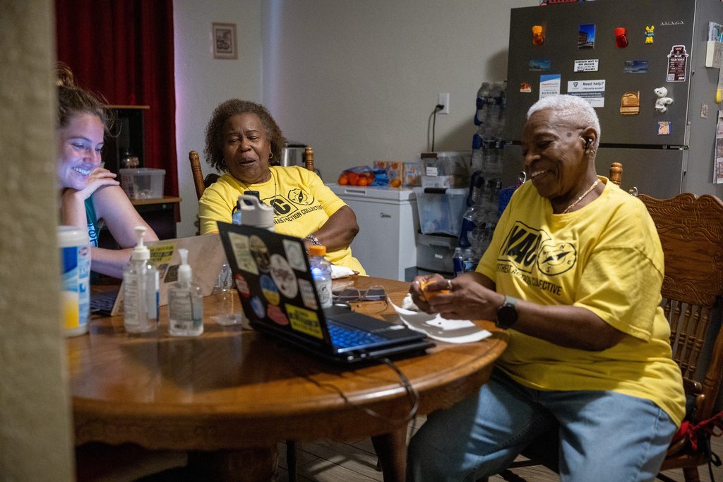 From left, Becky Selle, Leola Cornett-Traeye and Doris Brown sit at Brown's dinning table on Wednesday, Oct. 8, 2025, in Houston. (AP Photo/Antranik Tavitian)