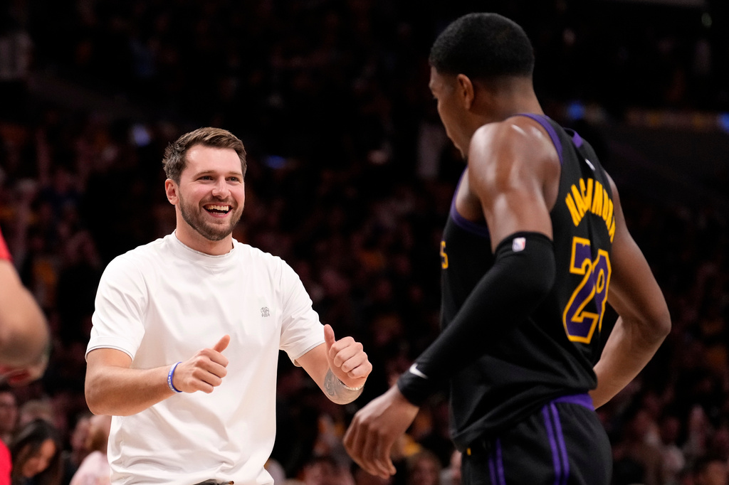 Los Angeles Lakers' Luka Doncic, left, celebrates with forward Rui Hachimura after the Lakers defeated the Houston Rockets in Game 2 of a first-round NBA playoffs basketball series Tuesday, April 21, 2026, in Los Angeles. (AP Photo/Mark J. Terrill)