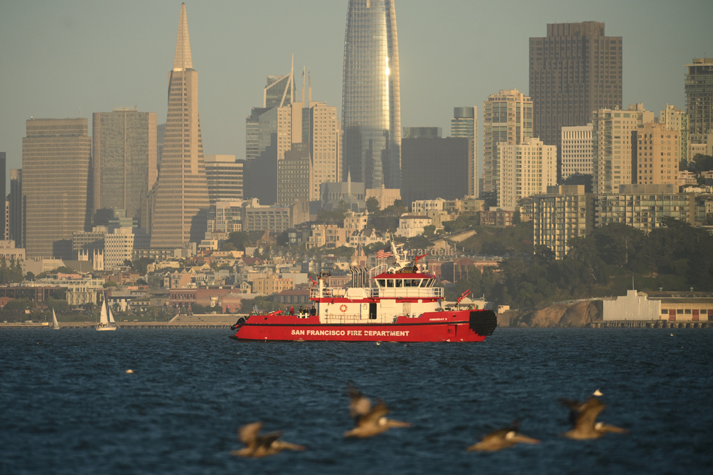 A San Francisco Fire Department vessel passes the city skyline while searching for missing victims after a boat accident near Alcatraz Island off San Francisco, Tuesday, July 14, 2026. (AP Photo/Noah Berger)