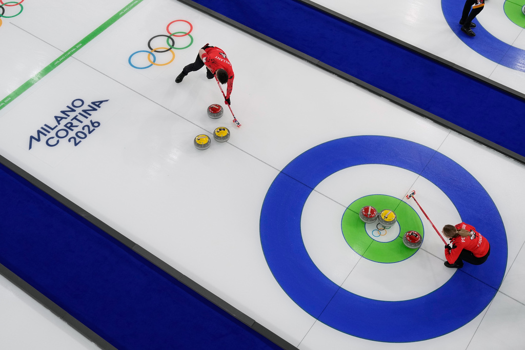 Canada's Brett Gallant and Jocelyn Peterman compete during a curling mixed doubles session against Czechia at the 2026 Winter Olympics in Cortina d'Ampezzo, Italy, Wednesday, Feb. 4, 2026. (AP Photo/David J. Phillip)