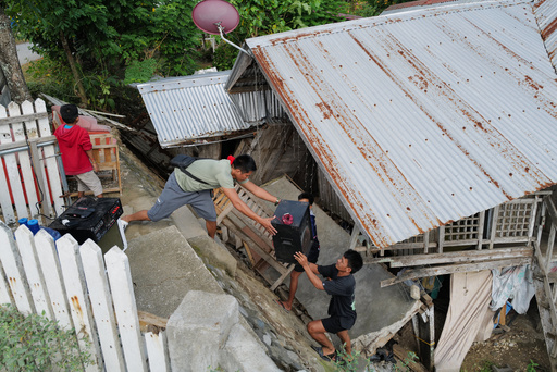 Residents bring out belongings from their earthquake damaged home as they evacuate to safer grounds at Manay town, Davao Oriental province, southern Philippines Saturday, Oct. 11, 2025. (AP Photo/Jeoffrey Maitem) Residents bring out belongings from their earthquake damaged home as they evacuate to safer grounds at Manay town, Davao Oriental province, southern Philippines Saturday, Oct. 11, 2025. (AP Photo/Jeoffrey Maitem)