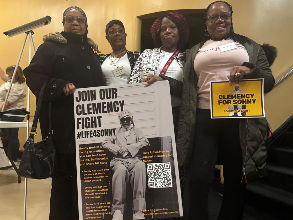 Eddie Mae Ellison, from left, Jackie Bradford, Mary Bradford and Lois Harris hold signs on Jan. 28, 2026, in Montgomery, Ala., urging Alabama Gov. Kay Ivey to grant clemency for their family member Charles "Sonny" Burton. (AP Photo/Kim Chandler)