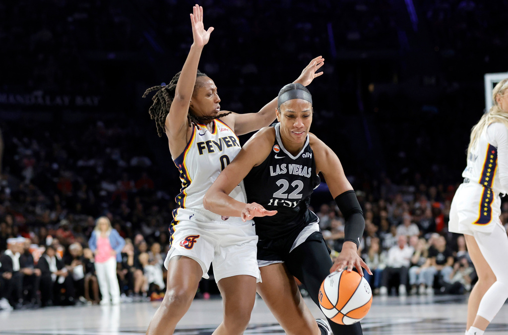 Las Vegas Aces center A'ja Wilson (22) drives against Indiana Fever guard Kelsey Mitchell (0) during the second half in Game 1 of a WNBA basketball first-round playoff series Sunday, Sept. 27, 2026, in Las Vegas. (AP Photo/Steve Marcus)