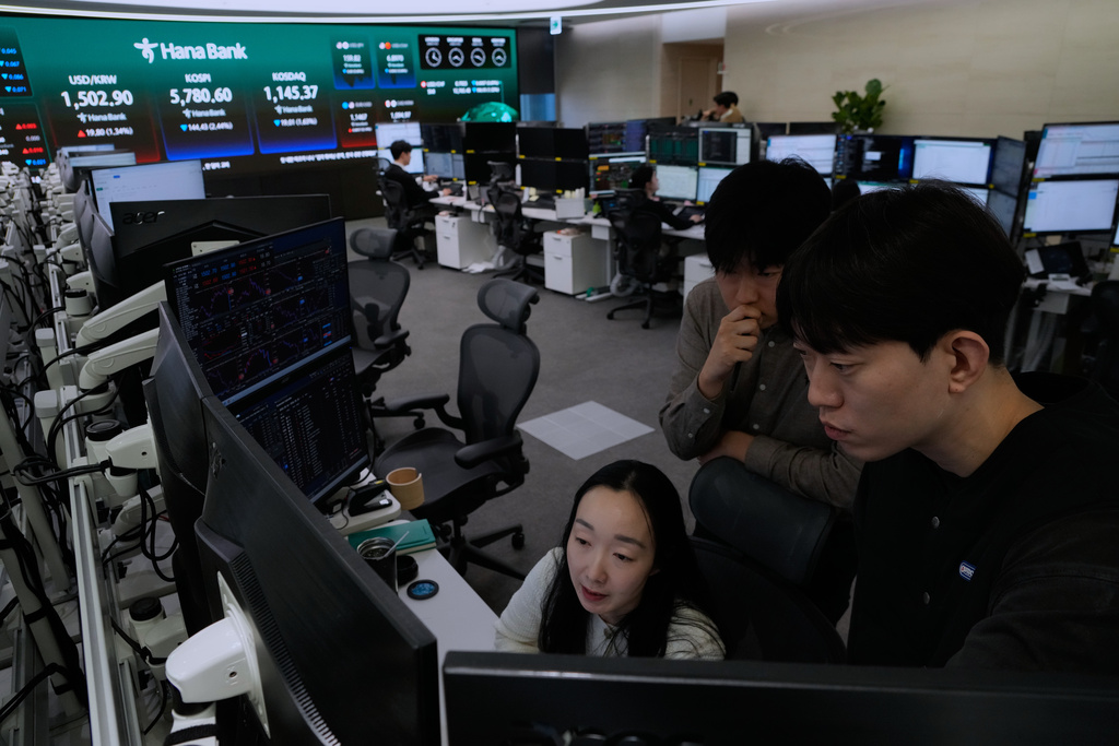 Currency traders watch monitors at the foreign exchange dealing room of the Hana Bank headquarters in Seoul, South Korea, Thursday, March 19, 2026. (AP Photo/Ahn Young-joon)