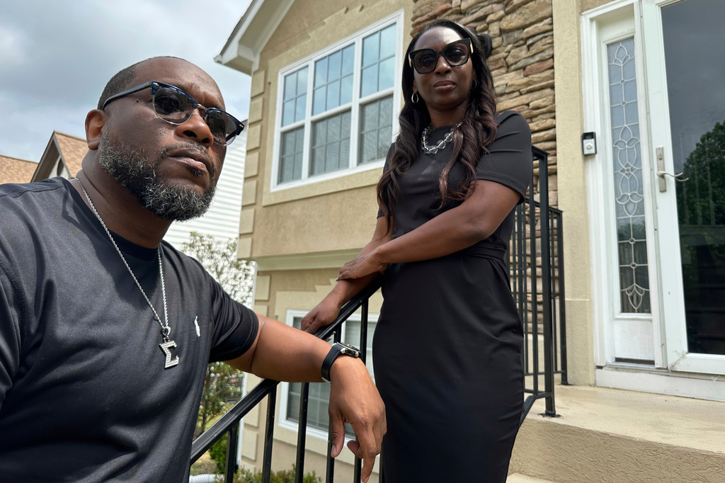 FILE - Toi Cliatt, left, and Trina Martin stand outside the home, which in 2017 the FBI mistakenly raided, on April 25, 2025, in Atlanta. (AP Photo/Sudhin Thanawala, File)
