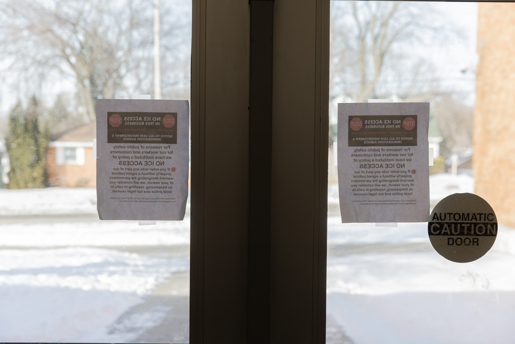 Signs reading "NO ICE ACCESS" taped to the front doors of Valley View Elementary School, Tuesday, Feb. 3, 2026, in Columbia Heights, Minn. (AP Photo/Liam James Doyle)