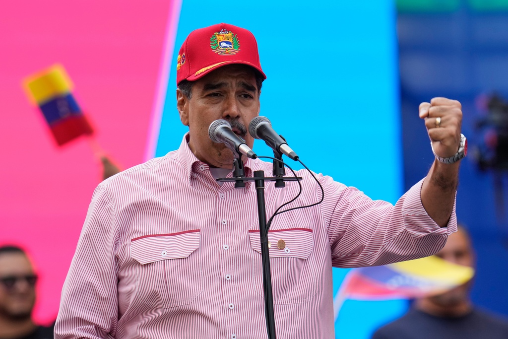 Venezuelan President Nicolas Maduro addresses supporters during a swearing-in event for government-organized community committees at the presidential palace in Caracas, Venezuela, Monday, Dec. 1, 2025. (AP Photo/Ariana Cubillos)