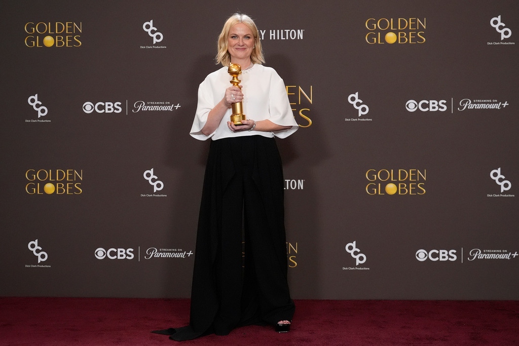 Amy Poehler poses in the press room with the award for best podcast for "Good Hang with Amy Poehler during the 83rd Golden Globes on Sunday, Jan. 11, 2026, at the Beverly Hilton in Beverly Hills, Calif. (AP Photo/Chris Pizzello)