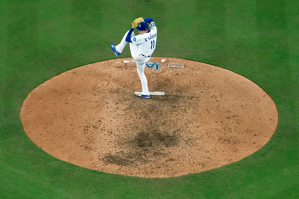 Los Angeles Dodgers pitcher Roki Sasaki throws against the Milwaukee Brewers during the ninth inning in Game 4 of baseball's National League Championship Series, Friday, Oct. 17, 2025, in Los Angeles. (AP Photo/Brynn Anderson)