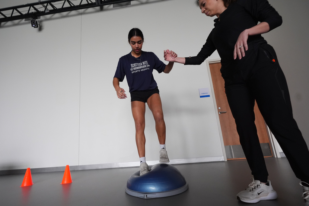 Plano East High School soccer player Sofia Tepichian, left, is helped by sports biomechanics researcher Sophia Ulman at the Movement Science Laboratory at Scottish Rite for Children in Frisco, Texas, Jan. 22, 2026. (AP Photo/LM Otero)