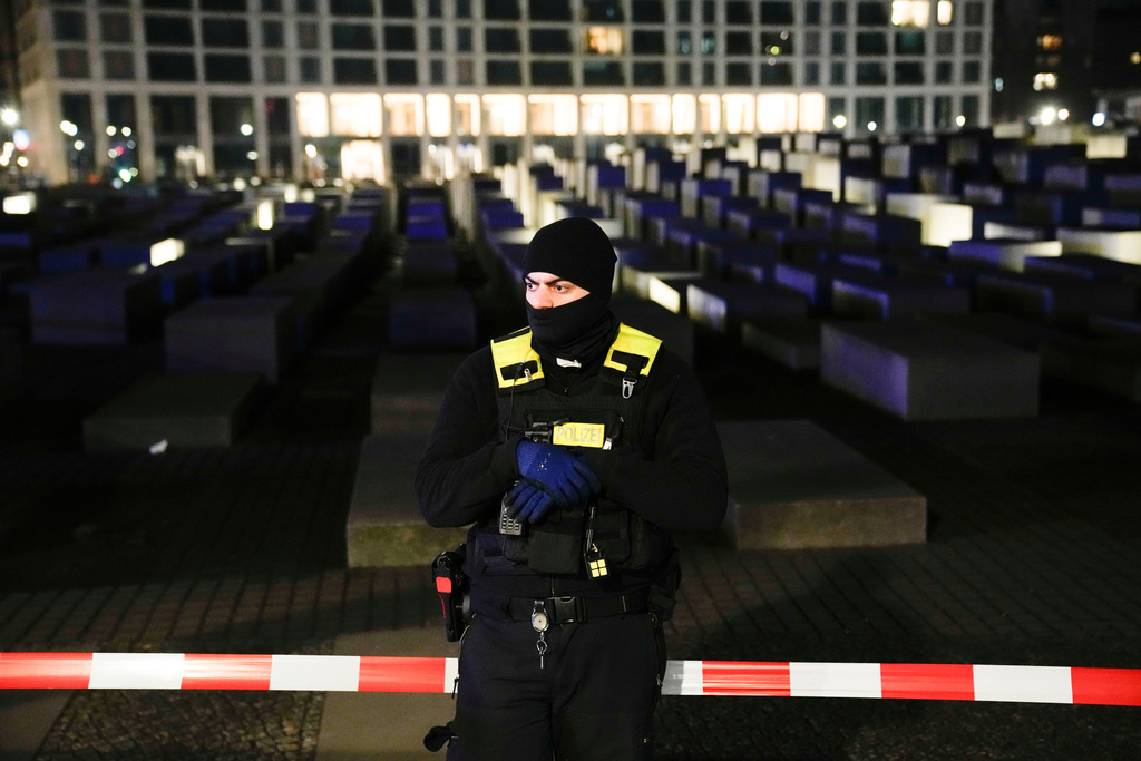 FILE -A police officer guards at the cordoned off Holocaust memorial after a man was attacked at the memorial site in Berlin, Germany, Feb. 21, 2025. (AP Photo/Ebrahim Noroozi, File)
