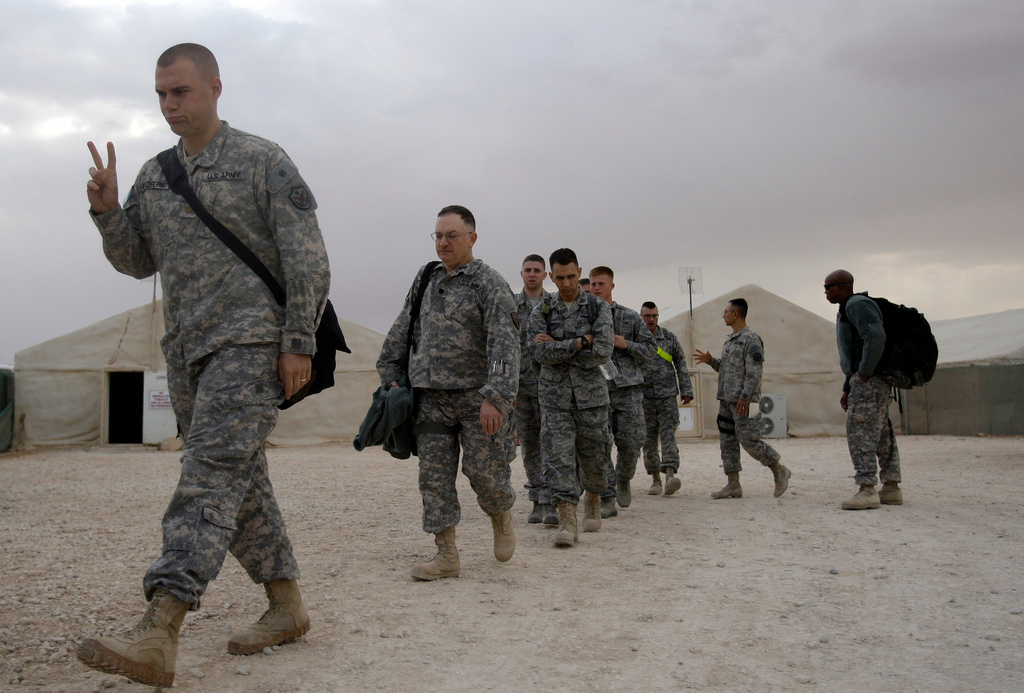 FILE - A U.S. army soldier flashes a V for victory sign as he begins his journey home, at the al-Asad Air Base west of Baghdad, Iraq, Nov. 1 , 2011. (AP Photo/Khalid Mohammed, File)