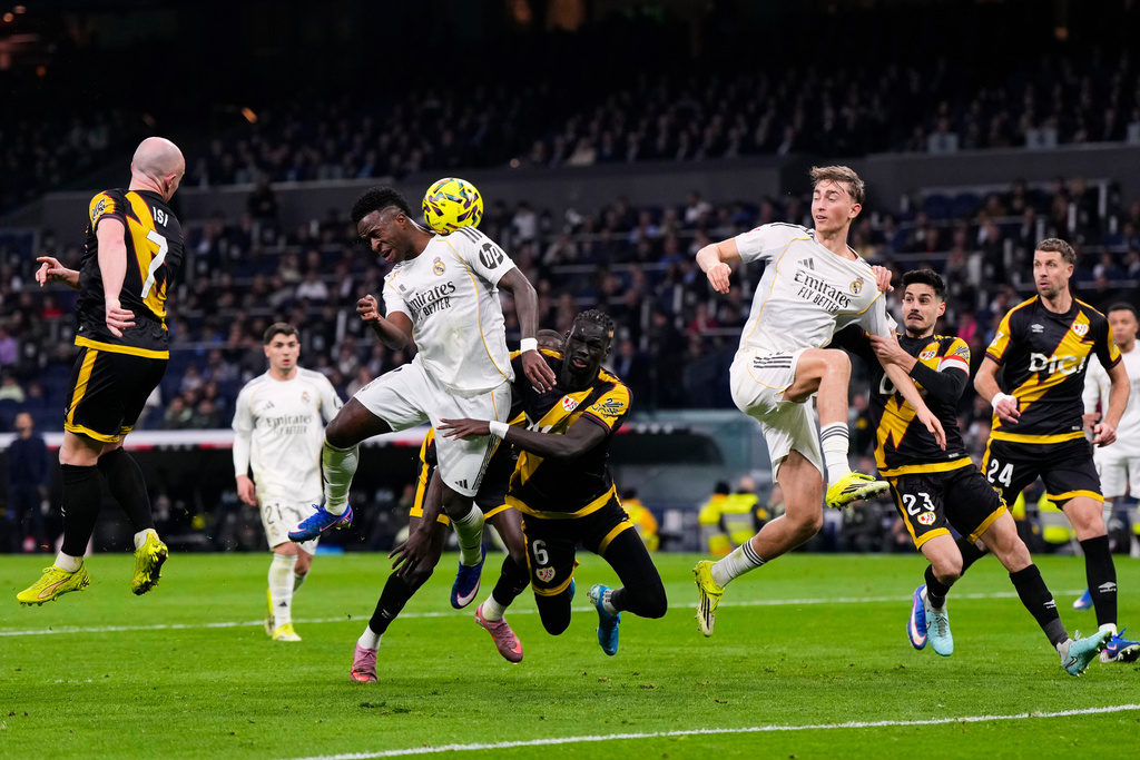 Real Madrid's Vinicius Junior, center left, heads for the ball during the Spanish La Liga soccer match between Real Madrid and Rayo Vallecano in Madrid, Spain, Sunday, Feb. 1, 2026. (AP Photo/Manu Fernandez)