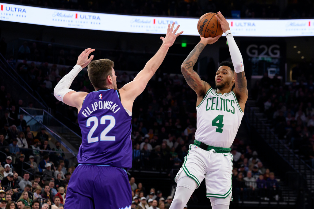 Boston Celtics guard Anfernee Simons (4) shoots over Utah Jazz forward Kyle Filipowski (22) during the first half of an NBA basketball game, Tuesday, Dec. 30, 2025, in Salt Lake City. (AP Photo/Tyler Tate)