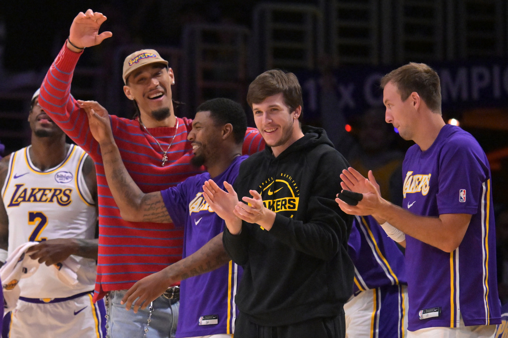 Los Angeles Lakers center Jaxson Hayes, left, Lakers' guard Marcus Smart (36), Lakers' guard Austin Reaves and guard Luke Kennard, right, react after a three-point basket by Lakers' forward Dalton Knecht (4) during the second half of an NBA basketball game against the Utah Jazz, April 12, 2026, in Los Angeles. (AP Photo/Jayne Kamin-Oncea)