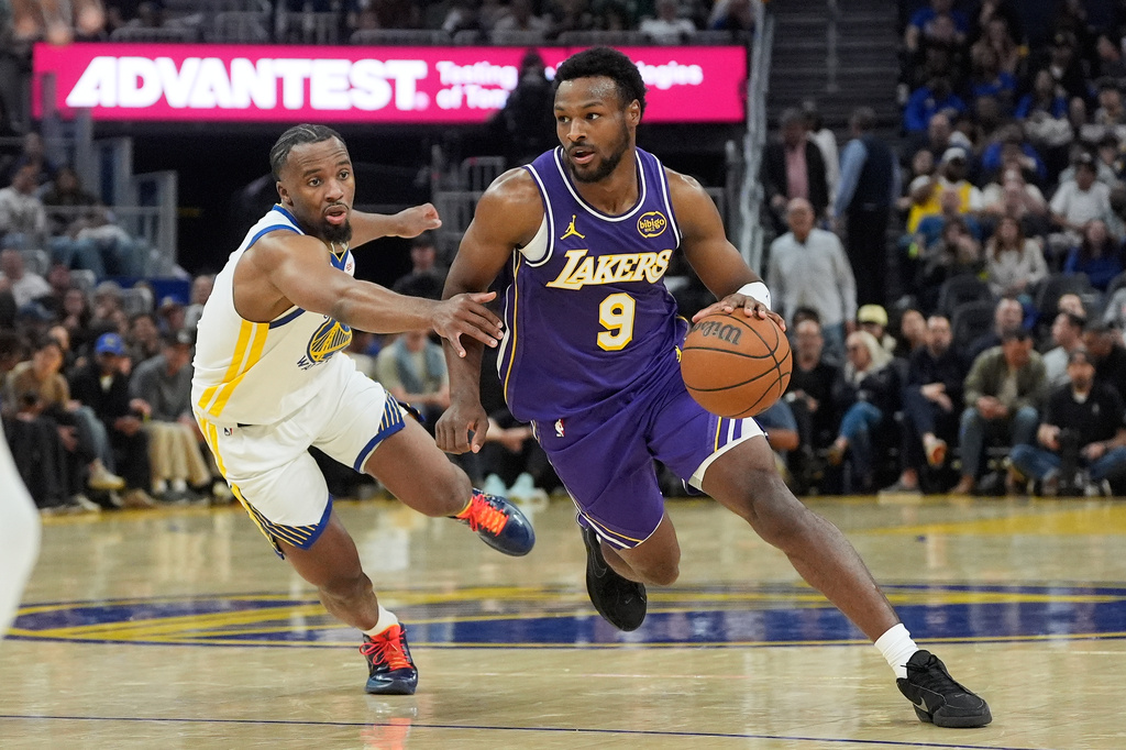 Los Angeles Lakers guard Bronny James (9) drives to the basket against Golden State Warriors guard LJ Cryer during the first half of an NBA basketball game in San Francisco, Thursday, April 9, 2026. (AP Photo/Jeff Chiu)