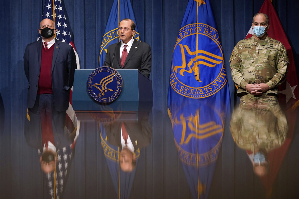 FILE - Health and Human Services Secretary Alex Azar, center, speaks during a news conference on Operation Warp Speed and COVID-19 vaccine distribution, Jan. 12, 2021, in Washington. Standing alongside Azar from left are Dr. Robert Redfield, director of the Centers for Disease Control and Prevention, and U.S. Army Gen. Gustave Perna, chief operating officer of Operation Warp Speed. (AP Photo/Patrick Semansky, Pool, File)