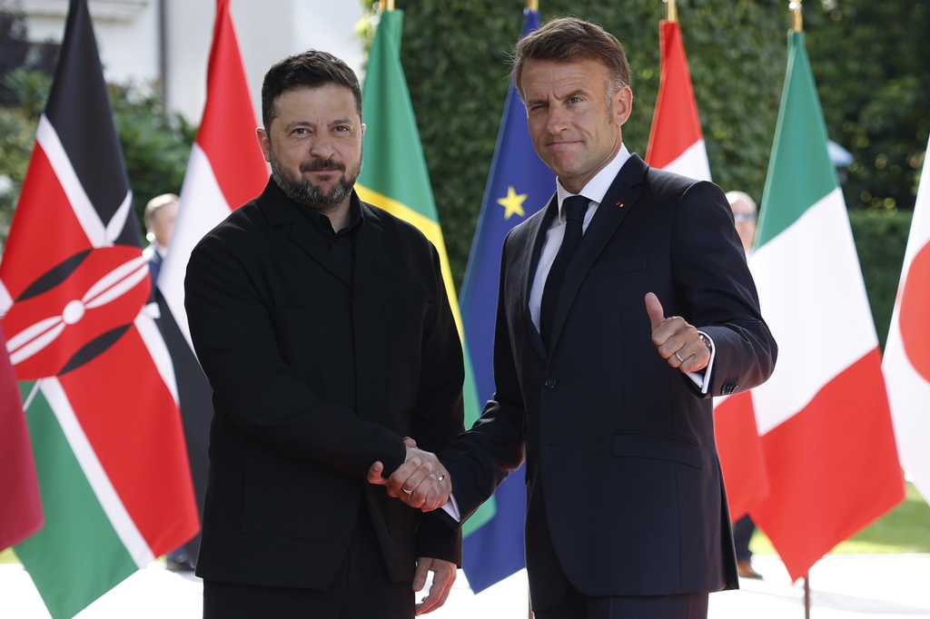French President Emmanuel Macron, right, welcomes Ukrainian President Volodymyr Zelenskyy at the Hotel Royal for the G7 Summit in Evian-les-Bains, France, Tuesday, June 16, 2026. (Yoan Valat/Pool Photo via AP)
