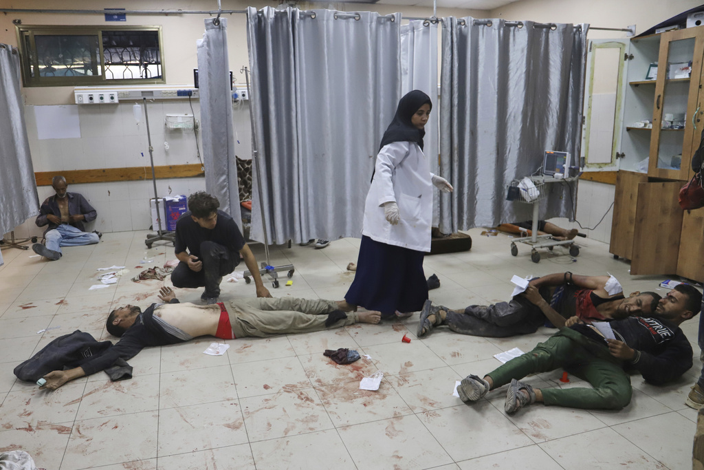 FILE - Palestinians who were injured during a food distribution at a center run by the Gaza Humanitarian Foundation, a U.S.-backed organization approved by Israel, receive treatment on the floor of Nasser Hospital in Khan Younis, southern Gaza Strip, Saturday, July 19, 2025. (AP Photo/Mariam Dagga, File)