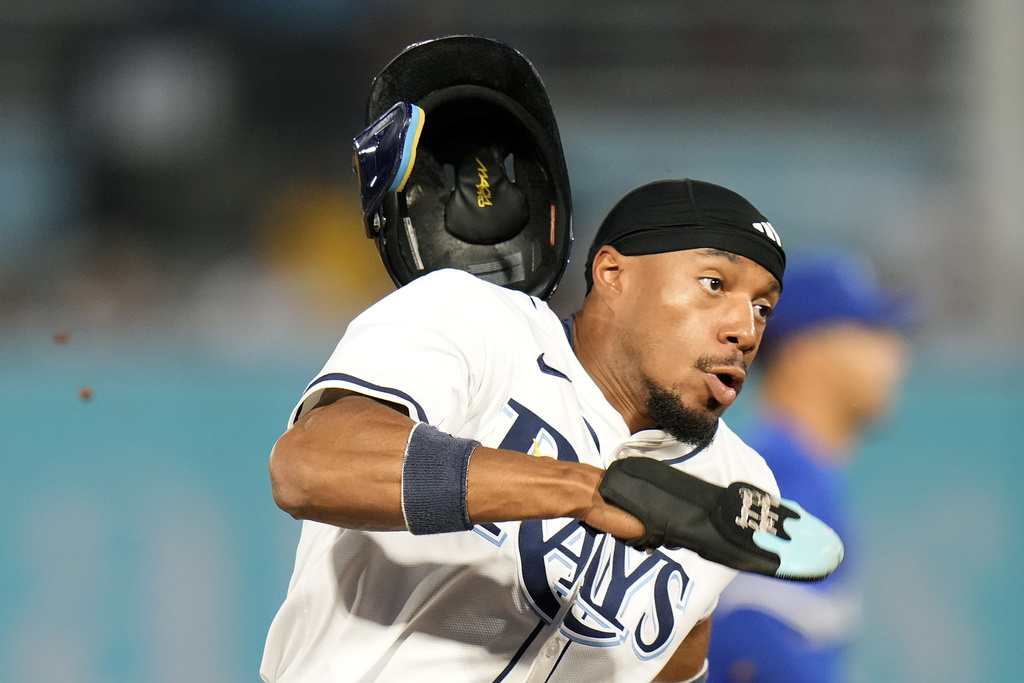 Tampa Bay Rays' Chandler Simpson loses his helmet as he scores on an RBI double by Yandy Díaz off Toronto Blue Jays pitcher Trey Yesavage during the first inning of a baseball game Monday, Sept. 15, 2025, in Tampa, Fla. (AP Photo/Chris O'Meara)