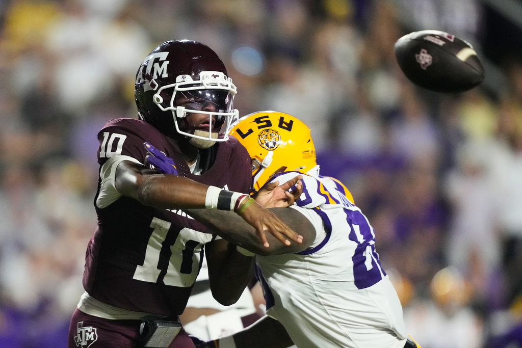 Texas A&M quarterback Marcel Reed (10) is hit by LSU defensive lineman Bernard Gooden (88) as he releases a pass in the first half of an NCAA college football game, Saturday, Oct. 25, 2025 in Baton Rouge, La. (AP Photo/Gerald Herbert)